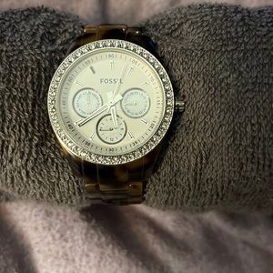 Dark tortoise shell band with silver and diamond face.